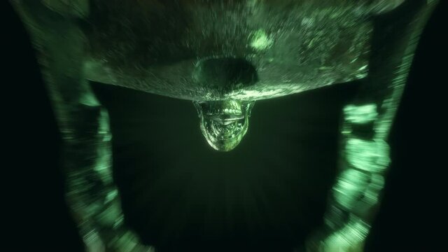 4K Skull Seamless animation horror loop of a realistic skeleton head opening jaw skeletons heads in the cemetary dark tunnel. Scary halloween background VJ loop