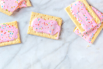 Vibrant pop tarts, shot from above on a marble background with a place for text