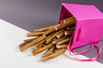 Beautiful pink gift box with pet treats. Bully sticks for dogs o