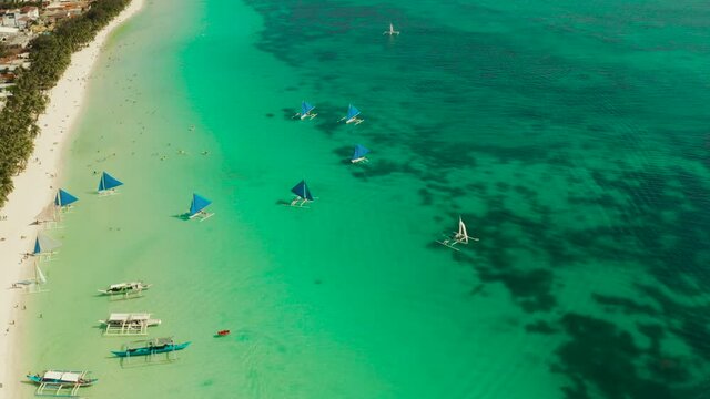 Tropical white sand beach, hotels near the blue lagoon and corall reef. aerial view, Boracay, Philippines. Seascape with beach on tropical island. Summer and travel vacation concept.