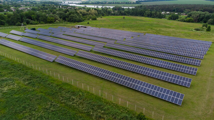Aerial view of Solar Panels Farm solar cell with sunlight. Drone flight over solar panels field, renewable green alternative energy concept.