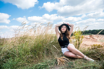 Portrait beautiful caucasian woman in the green field in summer time