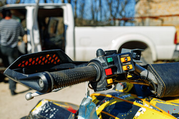 Handlebar of four-wheeled ATV quad bike close up
