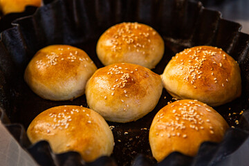Fresh homemade bread taken from the wood oven. Close up of rustic whole meal bread rolls