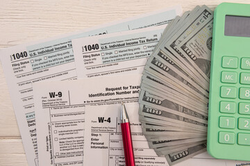 Naklejka premium 1040 individual form, with us money. Tax time concept