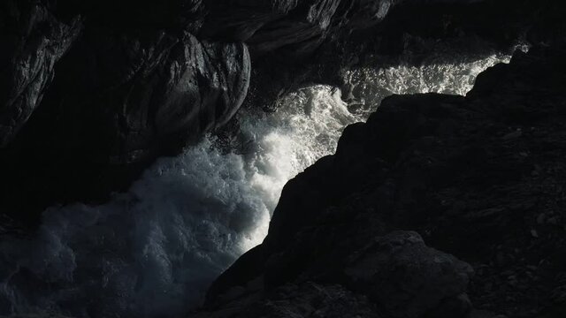 Slow motion water crushing on a cave.