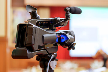 video camera in business conference room recording participants and speaker, seminar meeting, event...