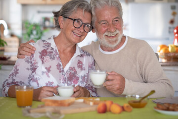 Obraz na płótnie Canvas Beautiful senior couple having breakfast at home. Retirement lifestyle
