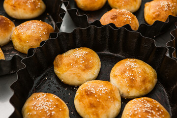 Fresh homemade bread taken from the wood oven. Close up of rustic whole meal bread rolls