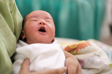 close up of new born infant asleep in the blanket in delivery room