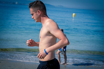 man running on the beach sand