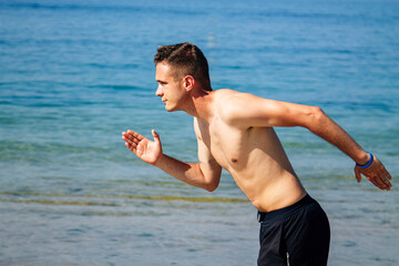man running on the beach sand