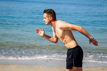 man running on the beach sand