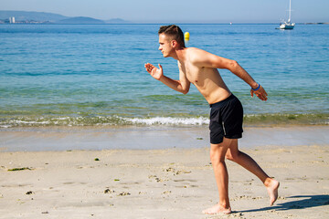 man running on the beach sand