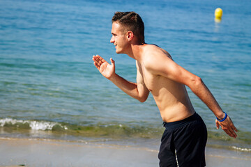 man running on the beach sand