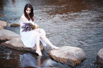 Pregnant woman in nature for a walk in the autumn