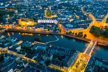 Fototapeta na wymiar Evening aerial view of the city of Laval and the Mayenne river. France