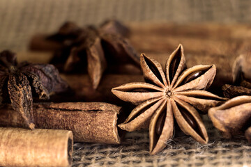 cinnamon sticks and star anise on burlap close-up.  Photo. macro