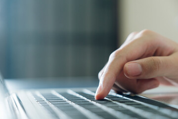 Finger on computer keyboard.