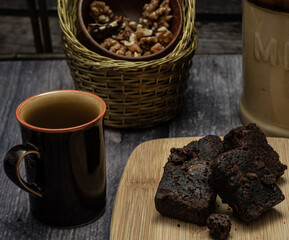 Brownies and a small bowl of shelled walnuts