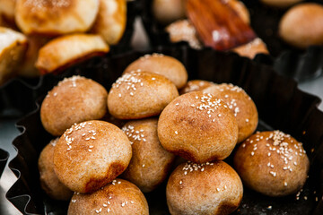 Fresh homemade bread taken from the wood oven. Close up of rustic whole meal bread rolls