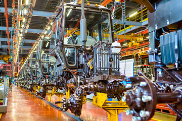 Industry and Manufacturing Concepts. Modern Tractors Machinery Assembly Line With Manufacturing Facilities Alongside.