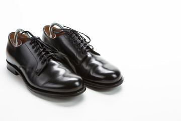 Footwear Concepts. Closeup of Pair of Male Stylish Black Polished Derby Calf Leather Laced Shoes.