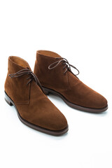 Male Footwear Ideas. Closeup of Pair of Mens Brown Suede Chukka Boots Against White Background.