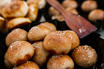 Fresh homemade bread taken from the wood oven. Close up of rustic whole meal bread rolls