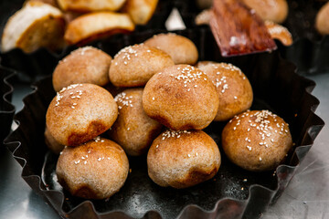 Fresh homemade bread taken from the wood oven. Close up of rustic whole meal bread rolls
