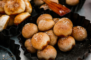 Fresh homemade bread taken from the wood oven. Close up of rustic whole meal bread rolls