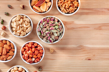 Nuts background with a place for text, overhead shot on a wooden background