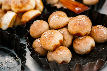Fresh homemade bread taken from the wood oven. Close up of rustic whole meal bread rolls