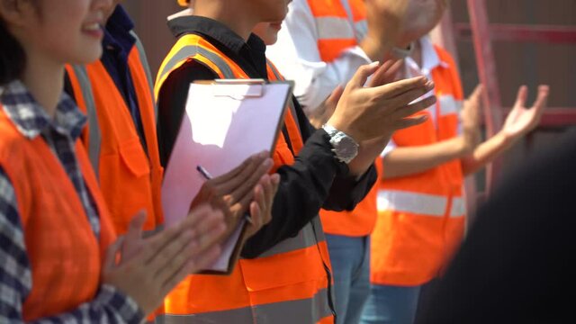 group of Containers worker excited and applauding in morning meeting . group of labor clapping hand to celebrate  at warehouse logistic in Cargo freight ship port
