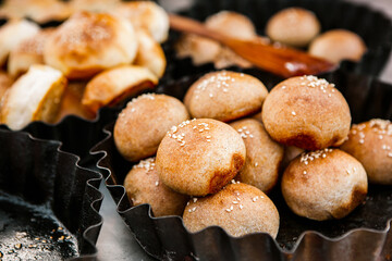 Fresh homemade bread taken from the wood oven. Close up of rustic whole meal bread rolls