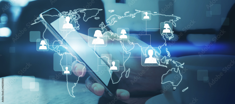 Poster Close up of hands at desktop using cellphone with glowing map and people icons. Social media and online recruiting concept. Double exposure.