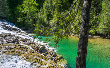 Fototapeta premium View on the beautiful emerald and transparent water of the Chute de La riviere aux Emeraudes near Percé in Gaspesie (Quebec, Canada)