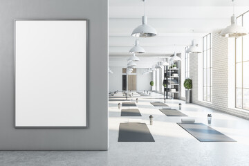 Modern bright white yoga studio gym interior with empty poster, window and city view. Mock up, 3D...