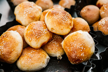 Fresh homemade bread taken from the wood oven. Close up of rustic whole meal bread rolls