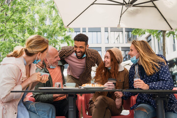 Reunion of family outdoors in city, life after covid-19 vaccination and back to normal concept.