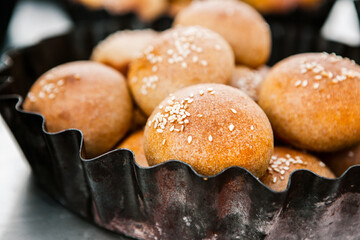Fresh homemade bread taken from the wood oven. Close up of rustic whole meal bread rolls