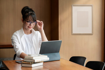 Beautiful woman working  on computer with happiness at her office.