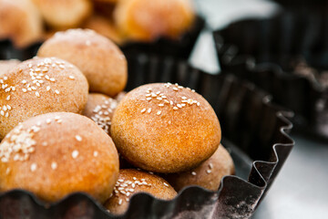 Fresh homemade bread taken from the wood oven. Close up of rustic whole meal bread rolls