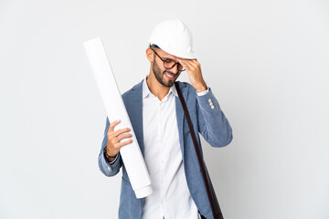 Young architect man with helmet and holding blueprints isolated on white background with headache