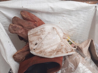 white kn95 masks that are dirty and cannot be used are thrown away with other garbage 