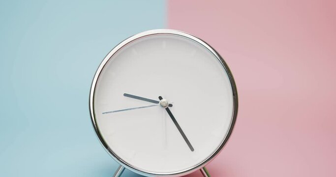 Close up zoom in detail Time Lapse - silver clock isolated on blue pink background, Time starts walking at 9 o'clock, Time lapse 6 hour.