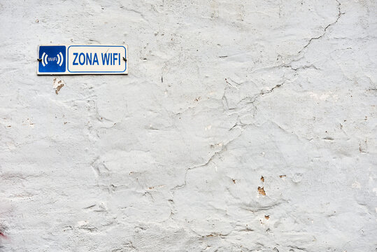 Detail of the old facade with sign "ZONA WIFI"