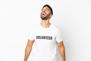 Young caucasian volunteer man isolated on white background laughing