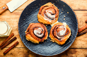 Delicious baked cinnabon buns with cream sauce