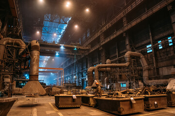 Large hangar or warehouse of Metallurgical Plant, dark industrial factory interior, heavy industry.